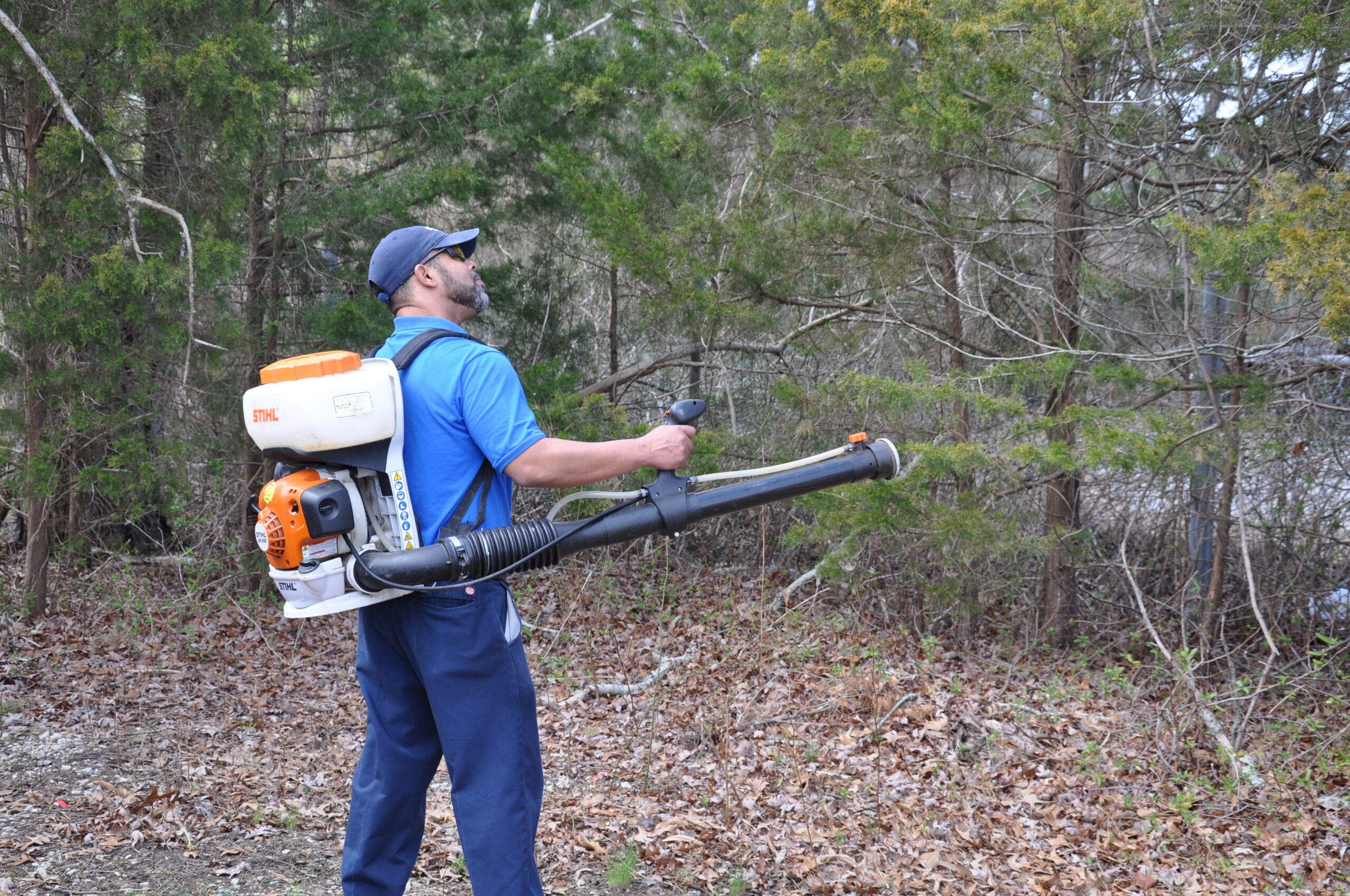 pest control tech spraying for mosquitos